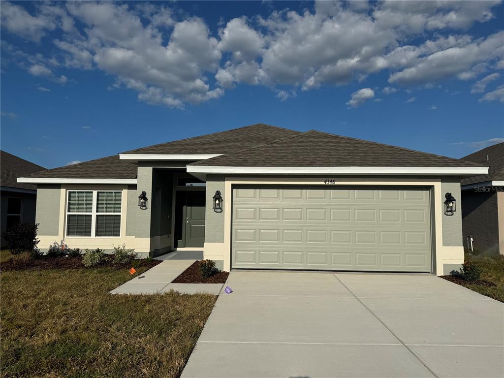 4348 Sutherland St Spring Hill Spring Hill, FL 34609 - Photo 1 of 1 a front view of a house with a yard and garage