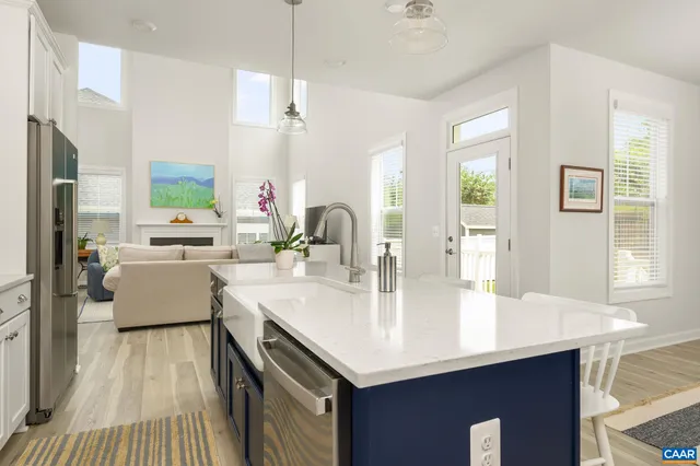 a kitchen with counter top space a sink appliances and cabinets