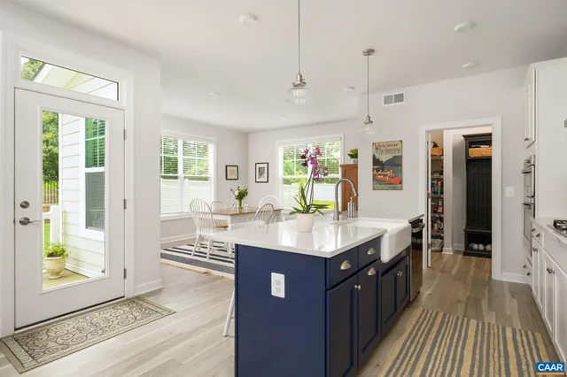 a kitchen with stainless steel appliances granite countertop a sink stove and a wooden floors