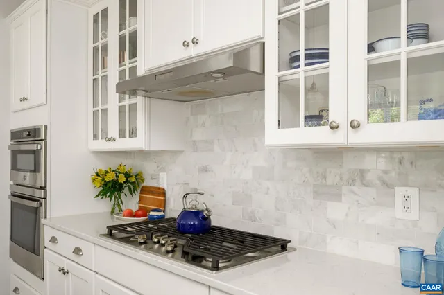 a kitchen with a stove and cabinets