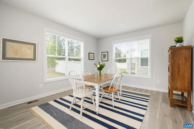 a dining room with furniture and wooden floor