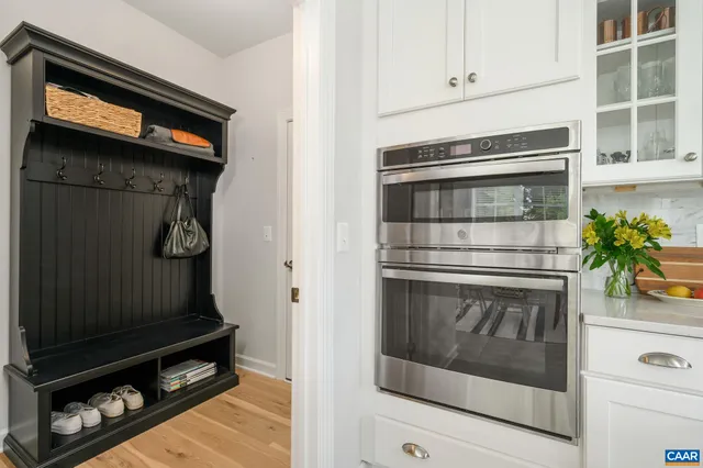 a kitchen with white cabinets and a stove
