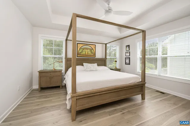 a bedroom with a bed and a large window