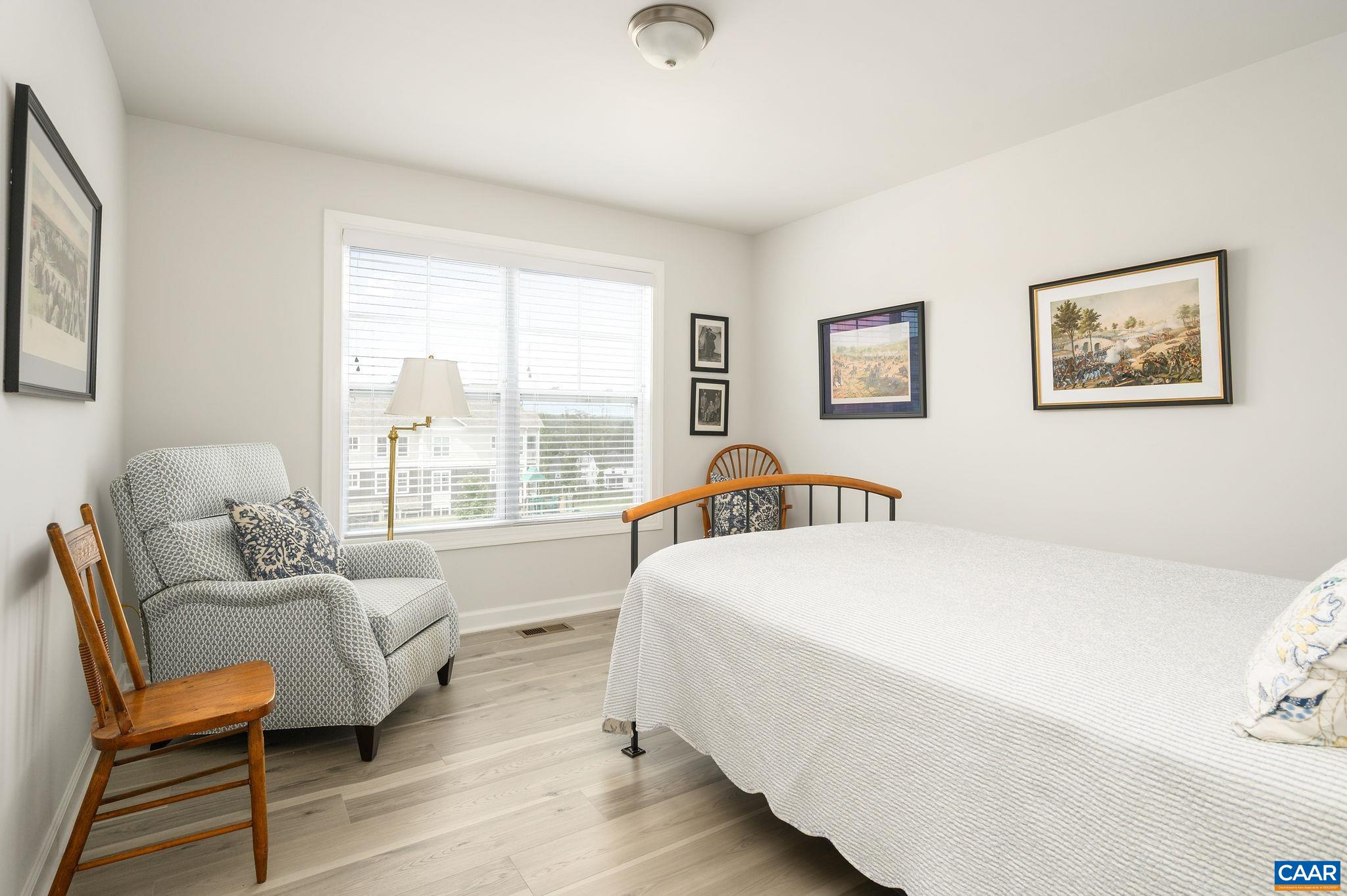 3526 Thicket Run Place Charlottesville, VA 22911 - Photo 23 of 36 a spacious bedroom with a bed and wooden floor
