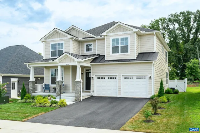 a front view of a house with a garden and plants