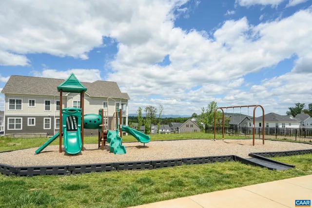 a view of a park with swings and slides