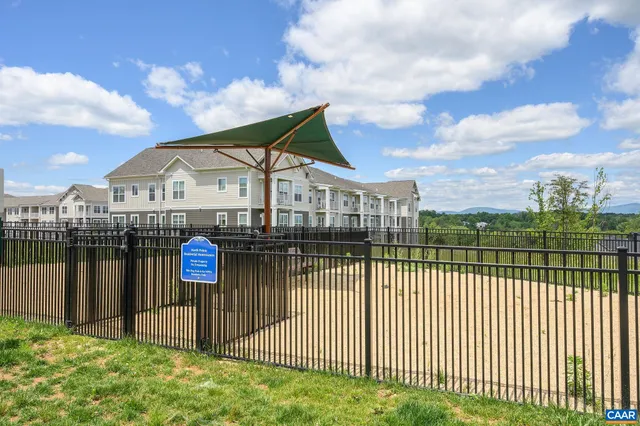a view of a houses with a wrought fence