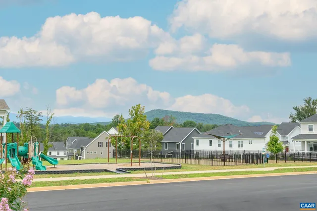 a view of swimming pool with outdoor seating and a yard in back