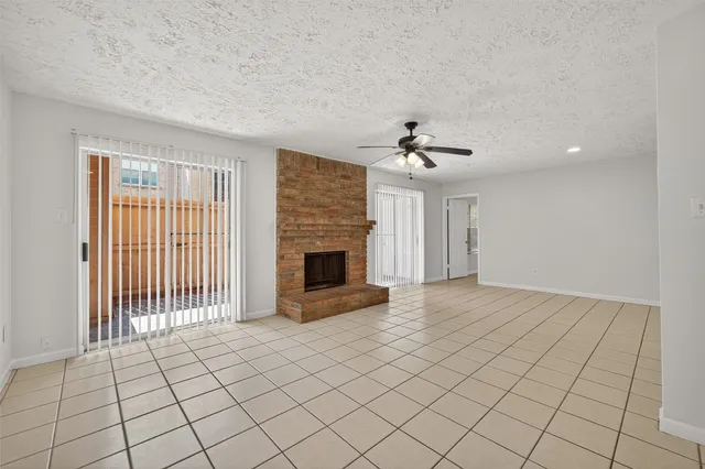 a view of an empty room with a fireplace