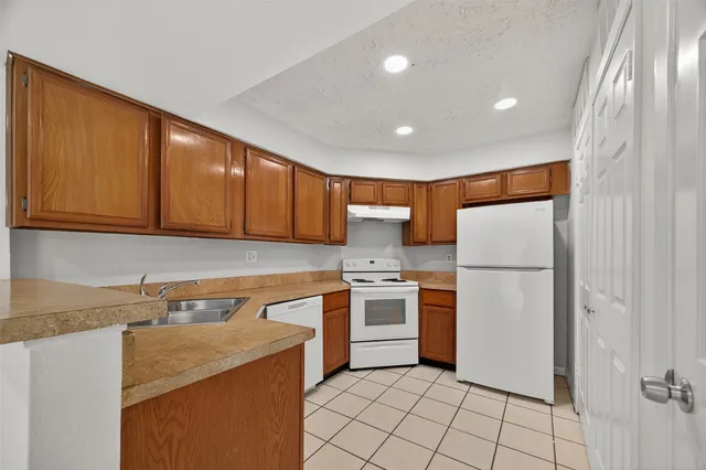 a kitchen with a sink cabinets and appliances