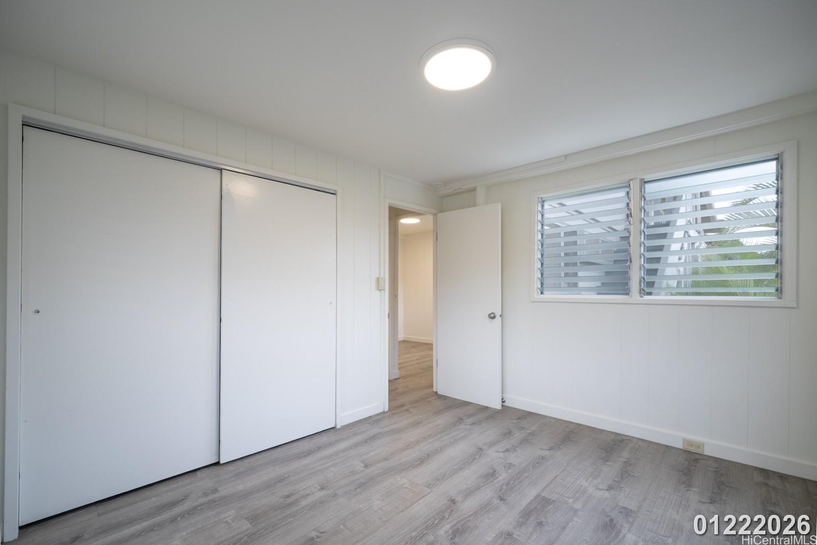 3033 Woolsey Place, Unit DOWNSTAIRS) Honolulu, HI 96822 - Photo 20 of 20 an empty room with wooden floor and windows