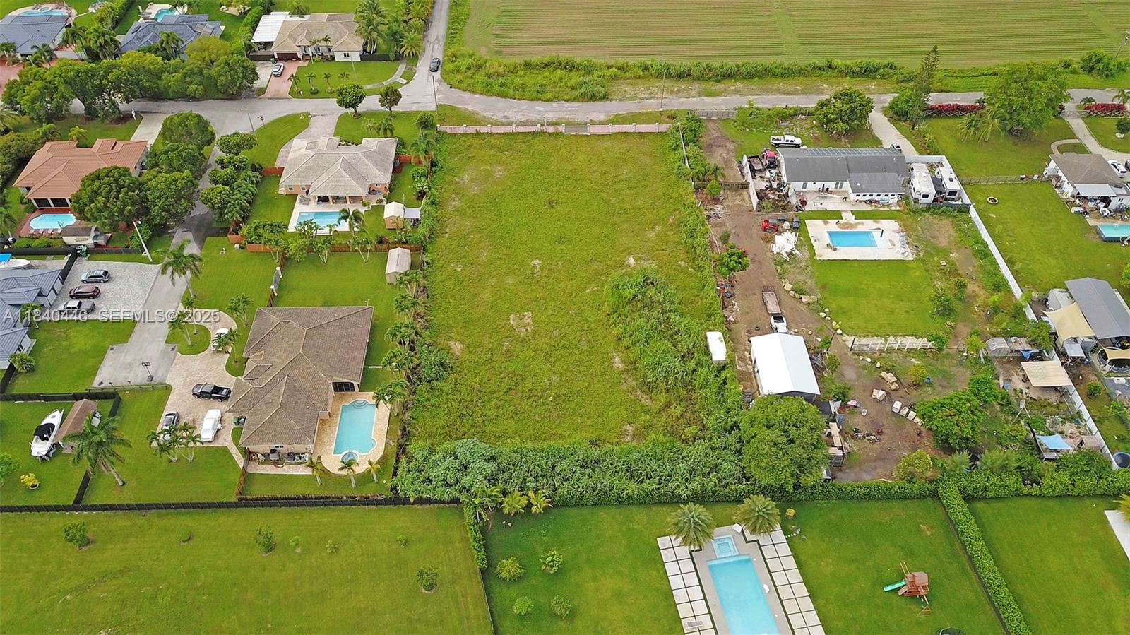 17399 Southwest 282nd Street Homestead, FL 33030 - Photo 4 of 6 an aerial view of residential houses with outdoor space and swimming pool