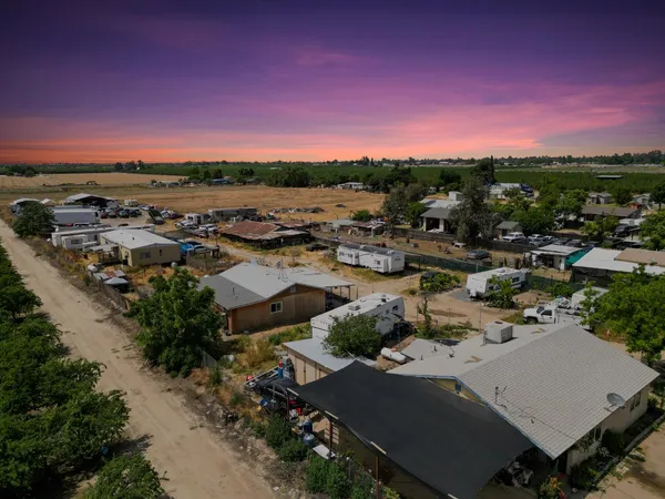 an aerial view of a house with a lot of trees