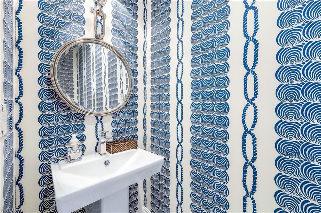 1135 3rd Avenue South, Unit 319 Naples, FL 34102 - Photo 13 of 19 a front view of a house with a table and a chair