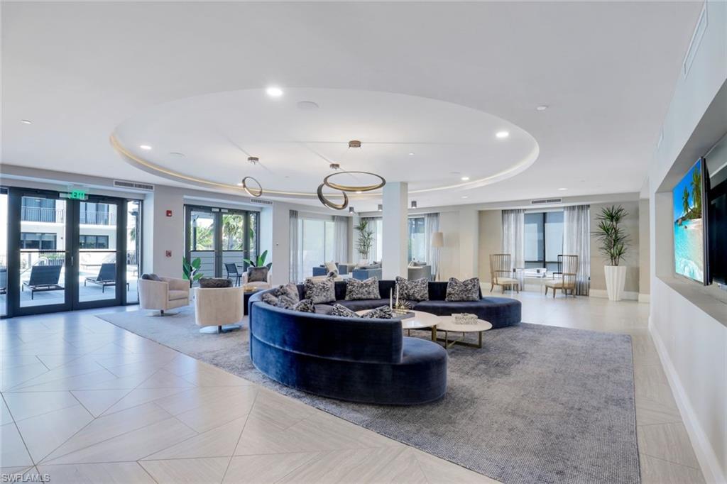 1135 3rd Avenue South, Unit 319 Naples, FL 34102 - Photo 18 of 19 a living room with furniture and a large window