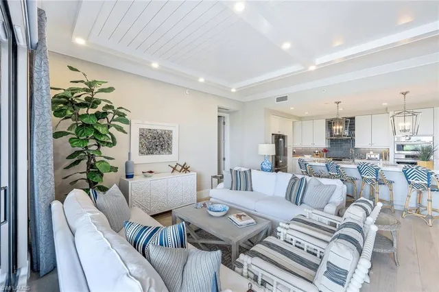 a living room with furniture and a dining table