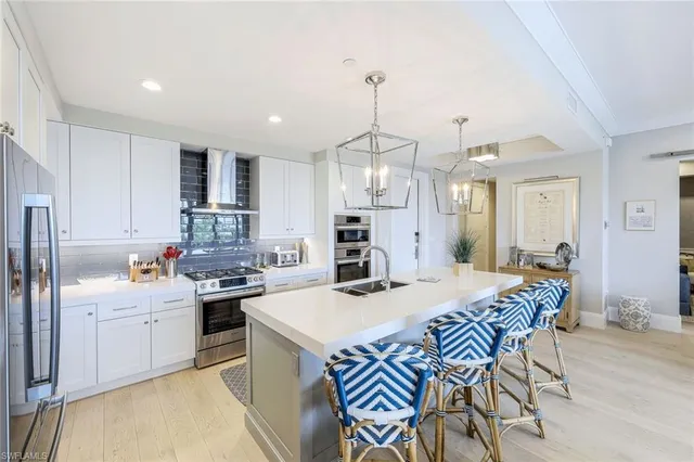 a large kitchen with a table and chairs