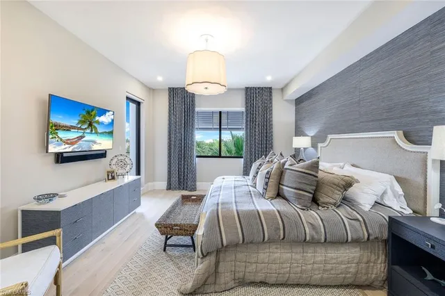 a bedroom with furniture and a flat screen tv