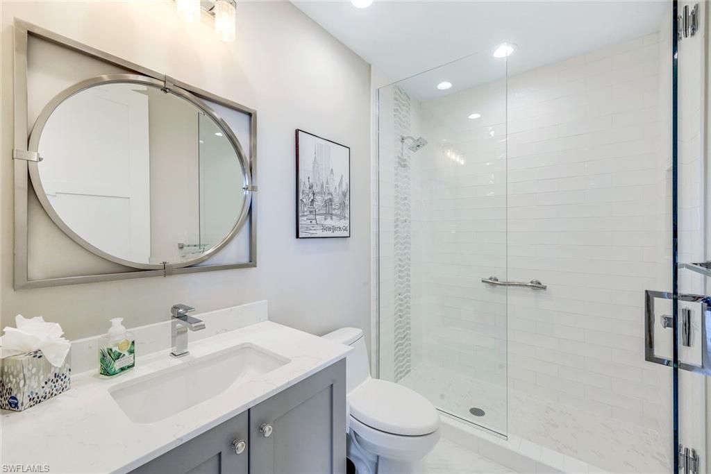 1135 3rd Avenue South, Unit 319 Naples, FL 34102 - Photo 10 of 19 a bathroom with a sink a toilet and shower