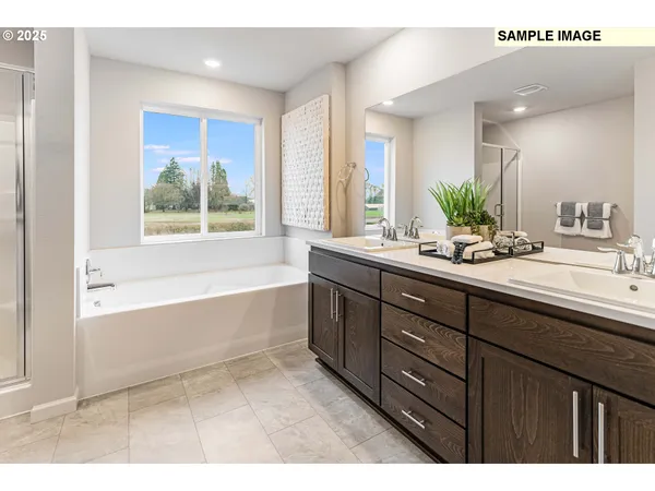 a bathroom with a tub sink and mirror