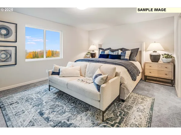 a spacious bedroom with a bed and wooden floor