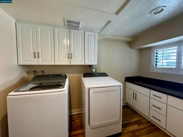 a utility room with closet dryer and washer