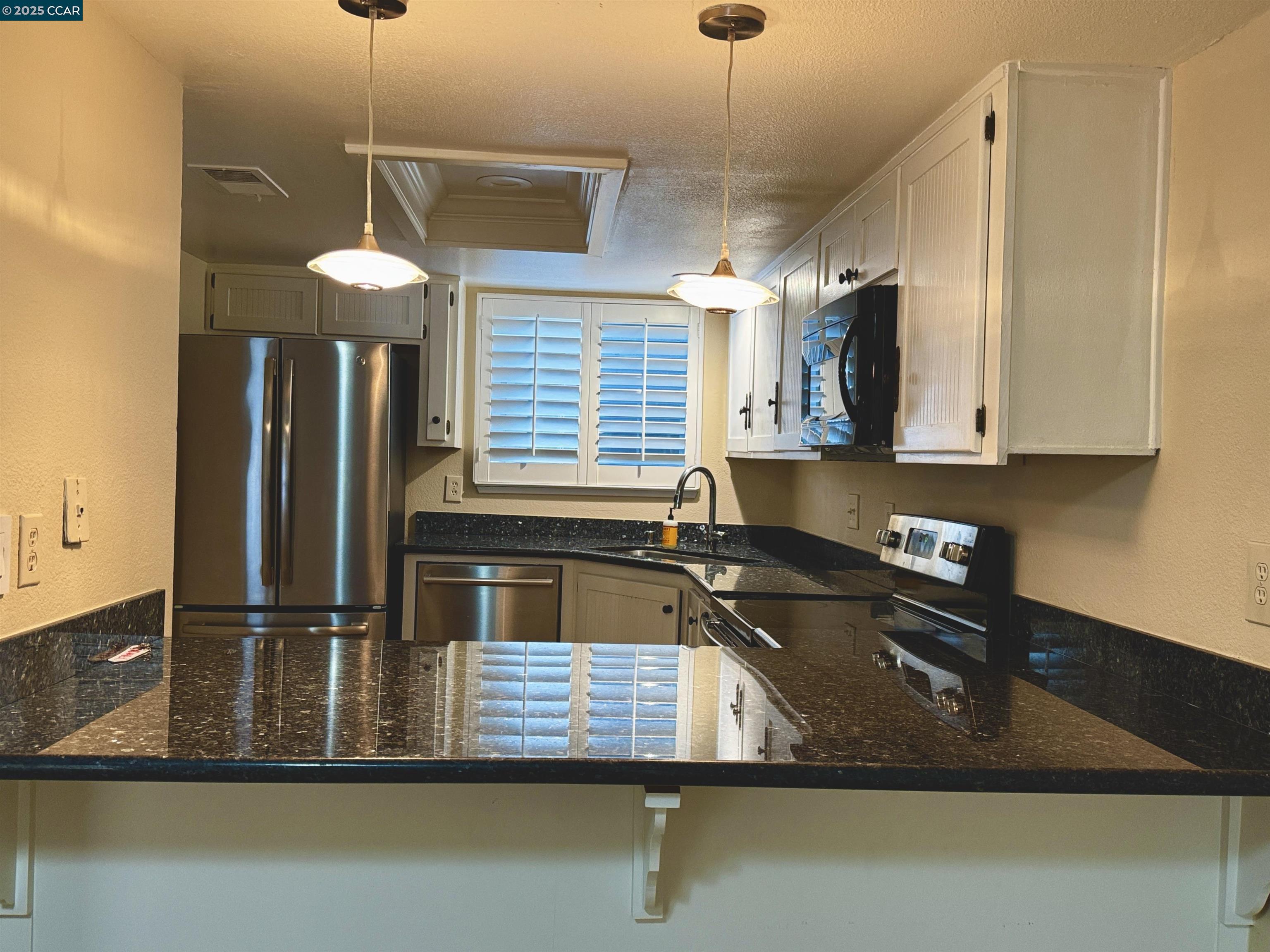 1640 San Miguel Drive Walnut Creek, CA 94596 - Photo 5 of 21 a kitchen with kitchen island a counter space a sink and appliances