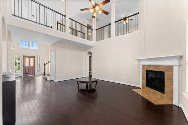 a view of a livingroom with wooden floor and a ceiling fan