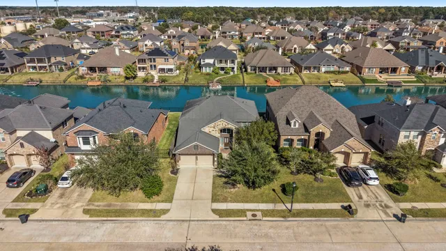 an aerial view of residential houses with outdoor space and parking