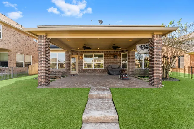 a view of a patio with table and chairs and potted plants