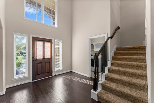 a view of an entryway with wooden floor and door