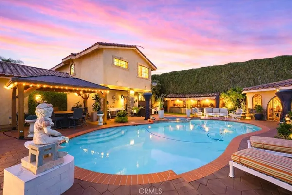 a view of a swimming pool with a patio and a yard