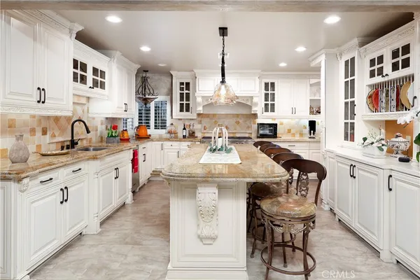 a kitchen with stainless steel appliances kitchen island granite countertop a sink and cabinets