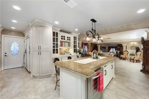 a kitchen with stainless steel appliances granite countertop a sink and a refrigerator