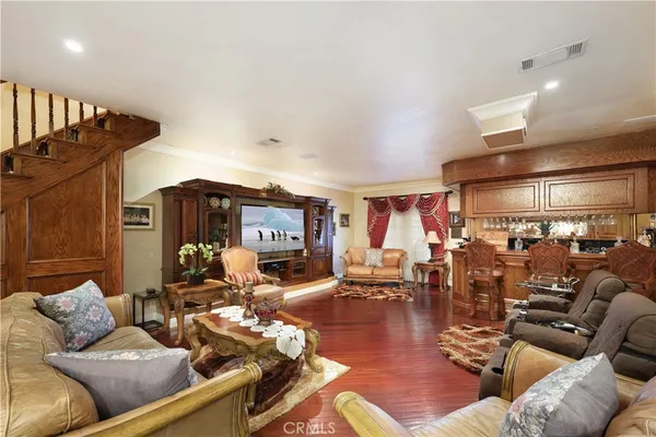 a living room with furniture and wooden floor