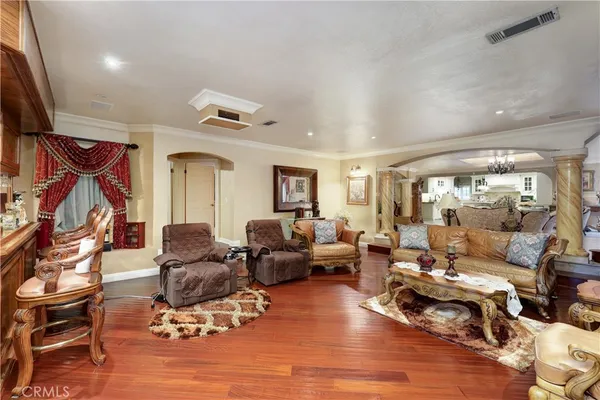 a living room with furniture and wooden floor