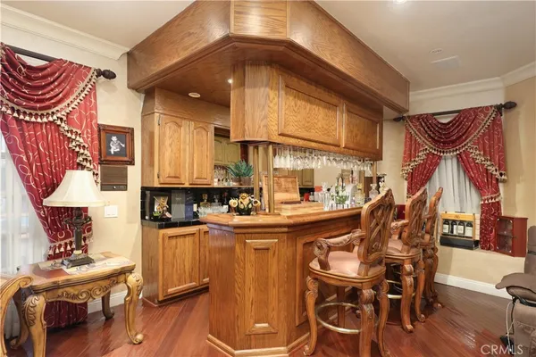 a view of a dining room with furniture and a chandelier