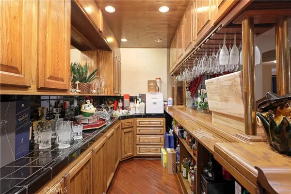 a kitchen with lots of counter top space and wooden floor