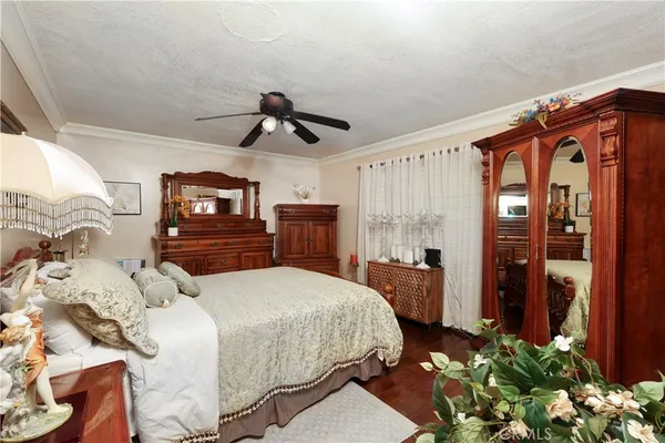 a bedroom with a bed dresser and mirror