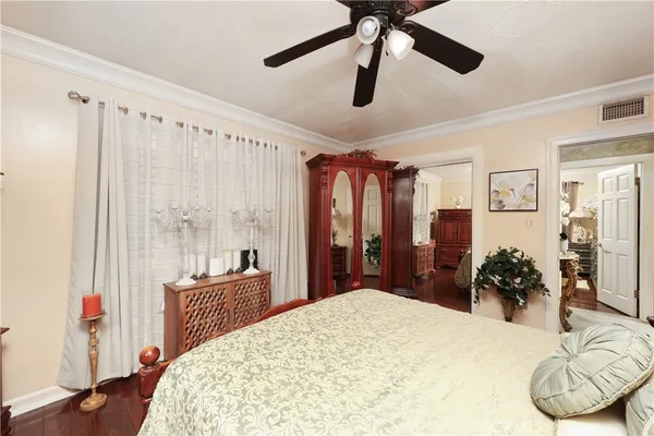 a bedroom with a bed dresser and a large mirror