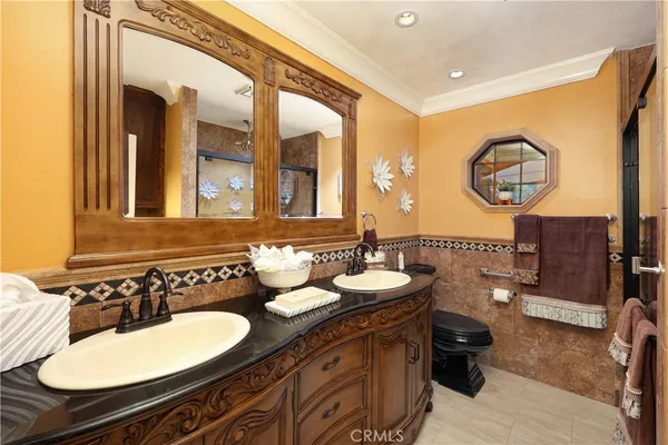 a bathroom with a double vanity sink and a mirror