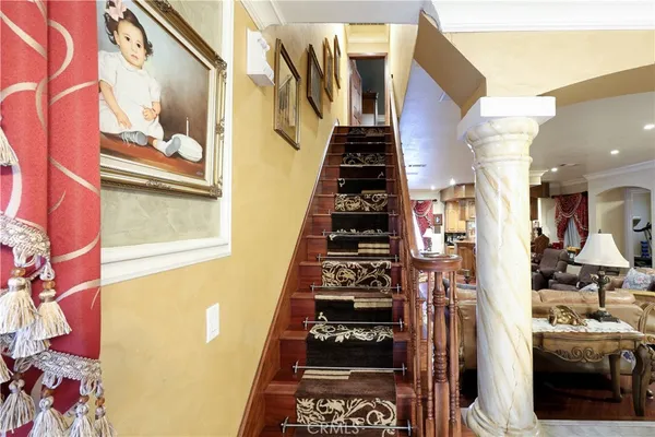 a living room with a bed and a chandelier