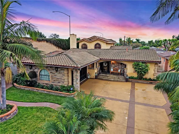 a view of a house with a yard balcony and sitting area
