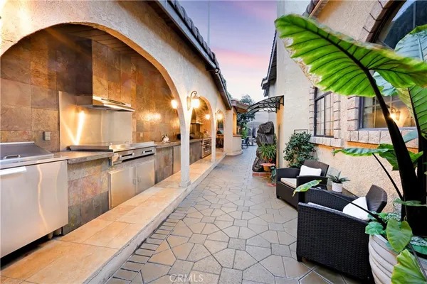a view of a house with swimming pool and sitting area