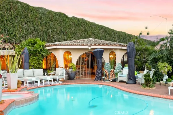 a view of a swimming pool with a patio and a yard