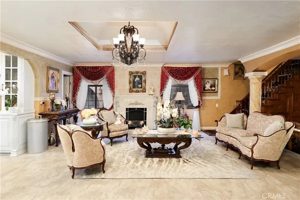 a living room with fireplace furniture and a chandelier