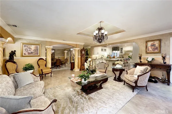 a living room with furniture and a chandelier
