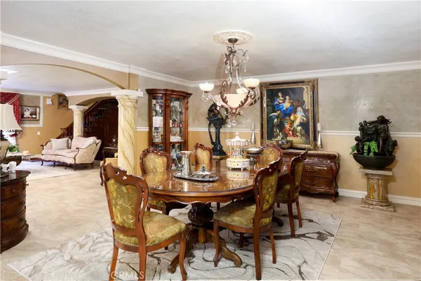 a view of a dining room with furniture and chandelier