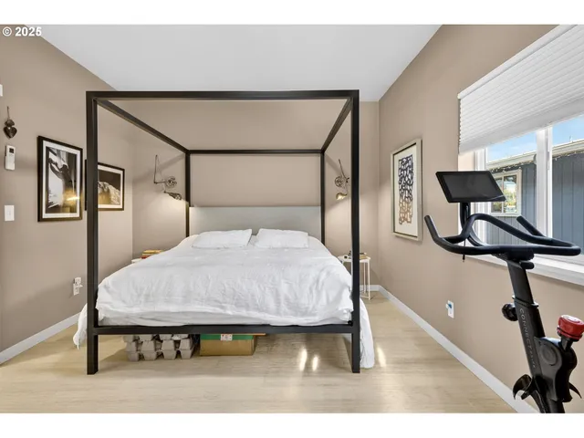 a bed sitting in a bedroom next to a window