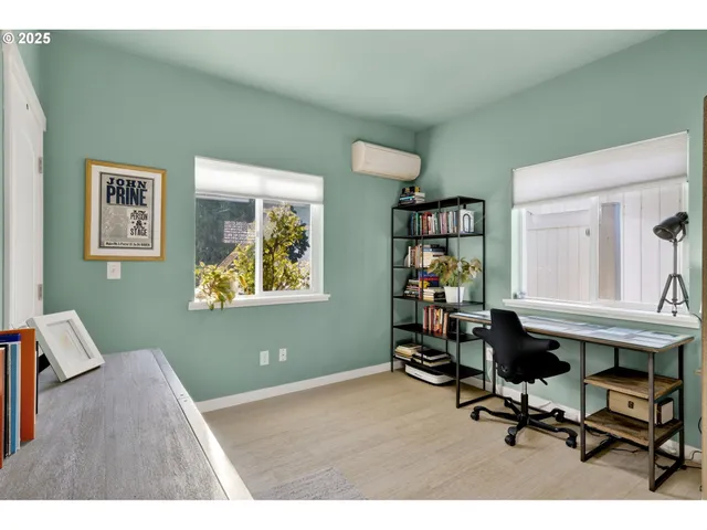 a view of a workspace with furniture and a window